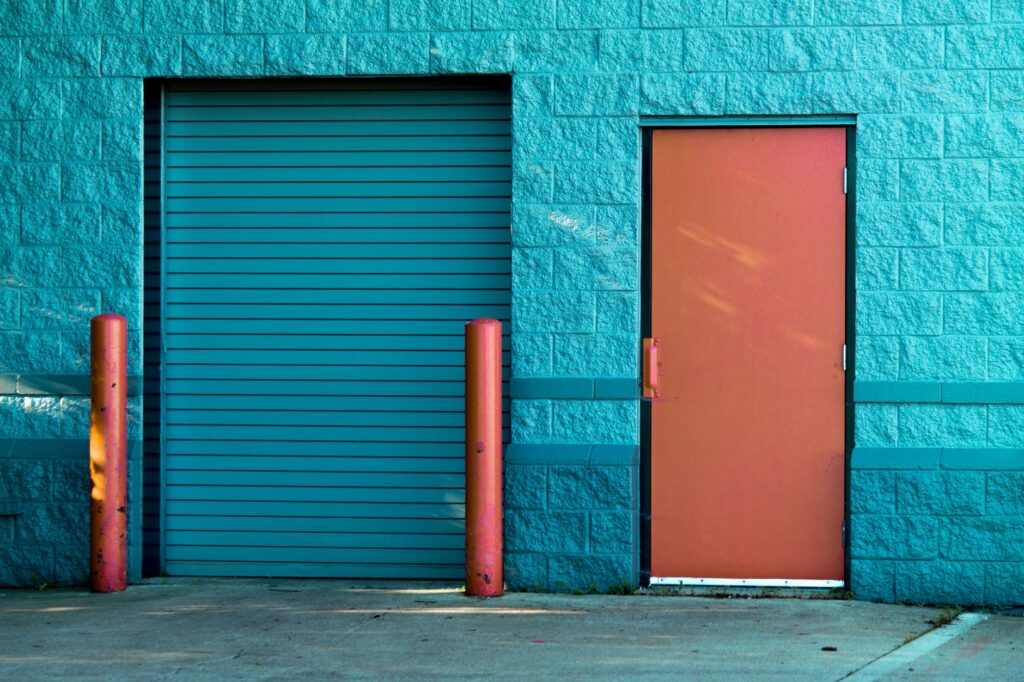 brown panel door near roll up gate